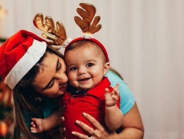 Mother and her baby playing at home on Christmas holiday