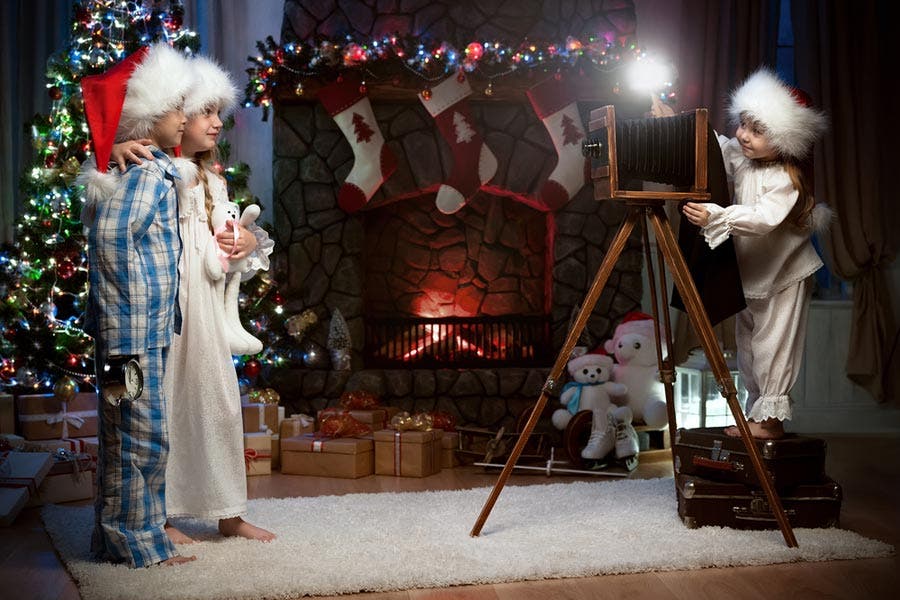 children taking photos around the Christmas tree
