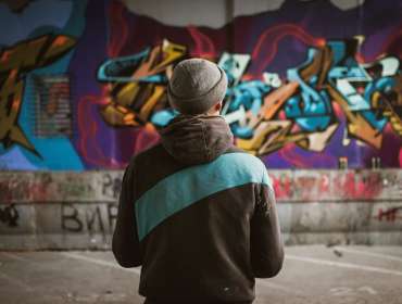 man looking at street art