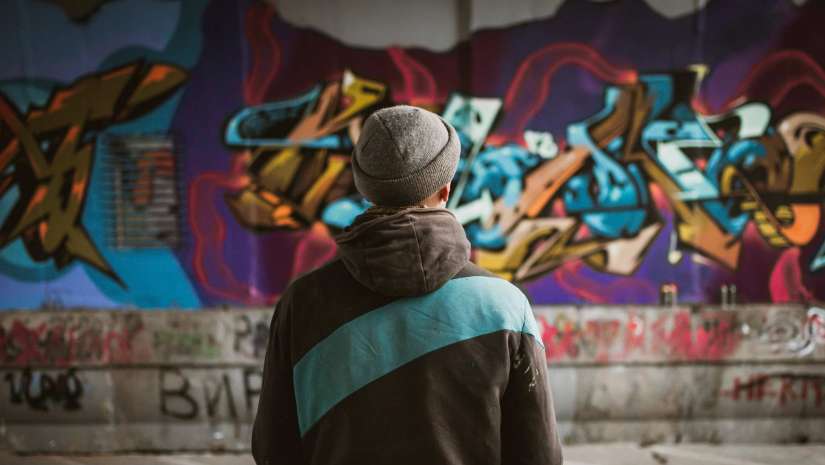man looking at street art
