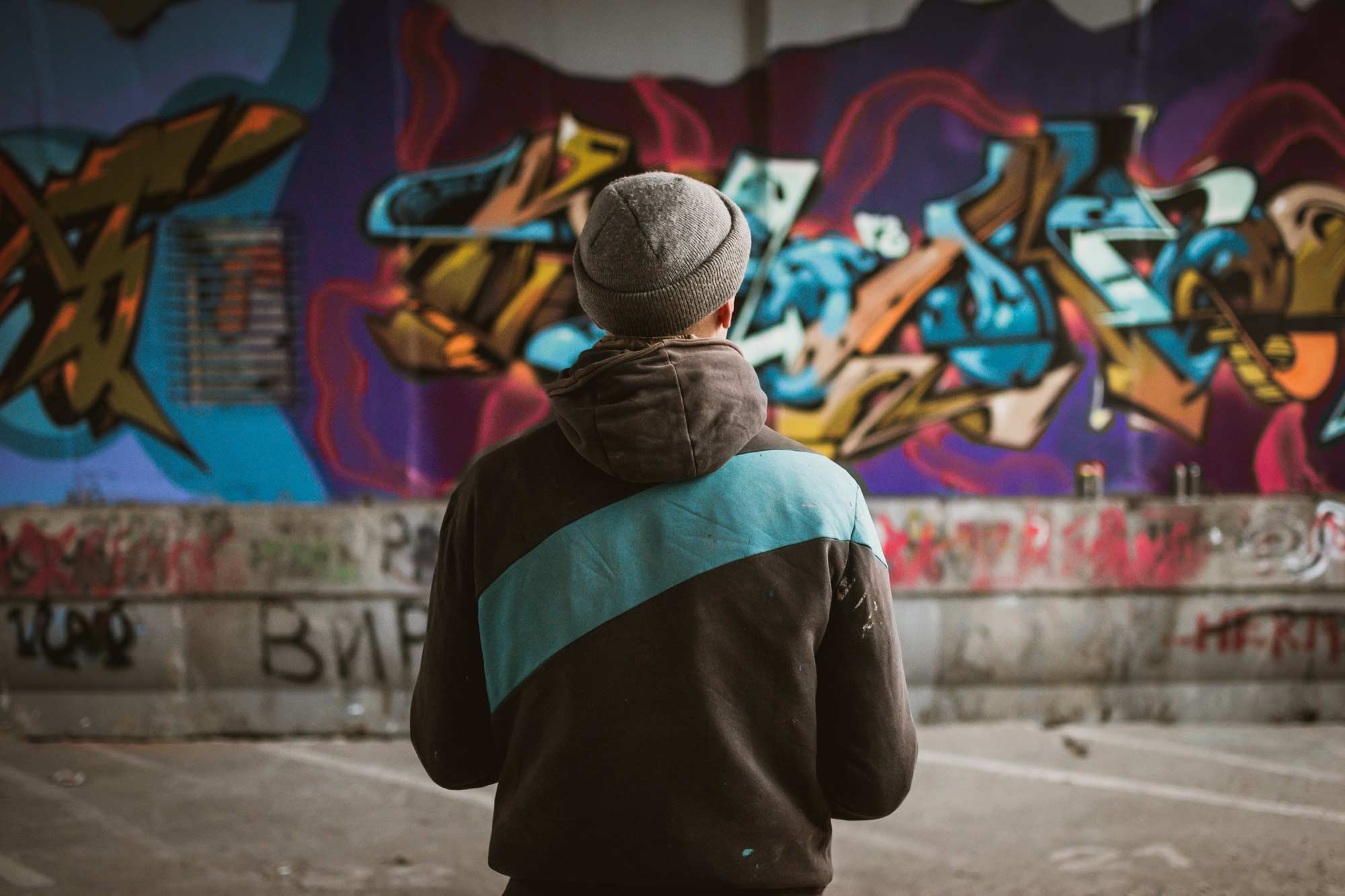 man looking at street art