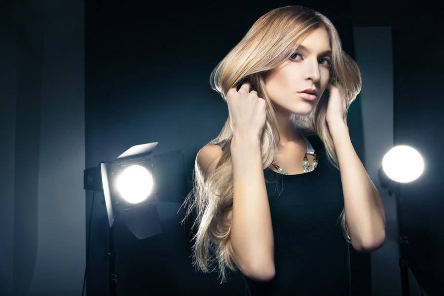 Model under professional studio lighting with three flashes