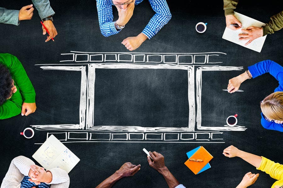 Top view shot of film production team brainstorming