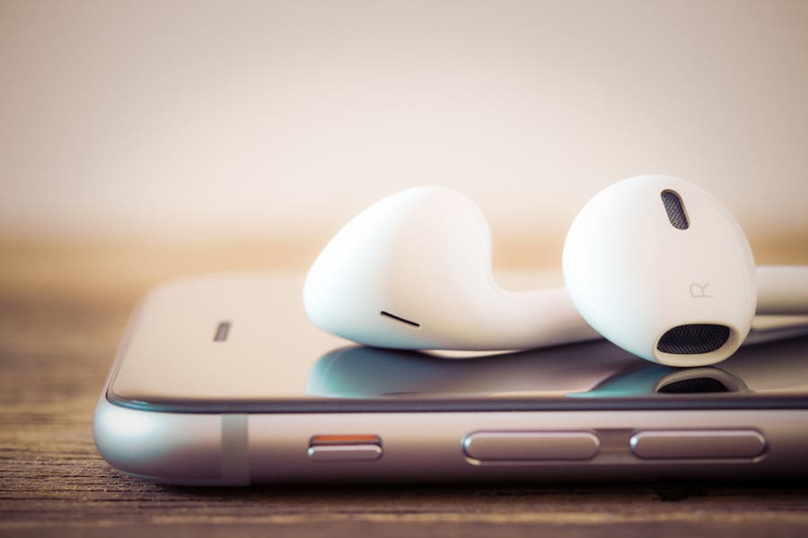 Podcast concept with earphones and cellphone