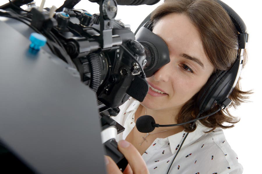 Girl operating cinema camera