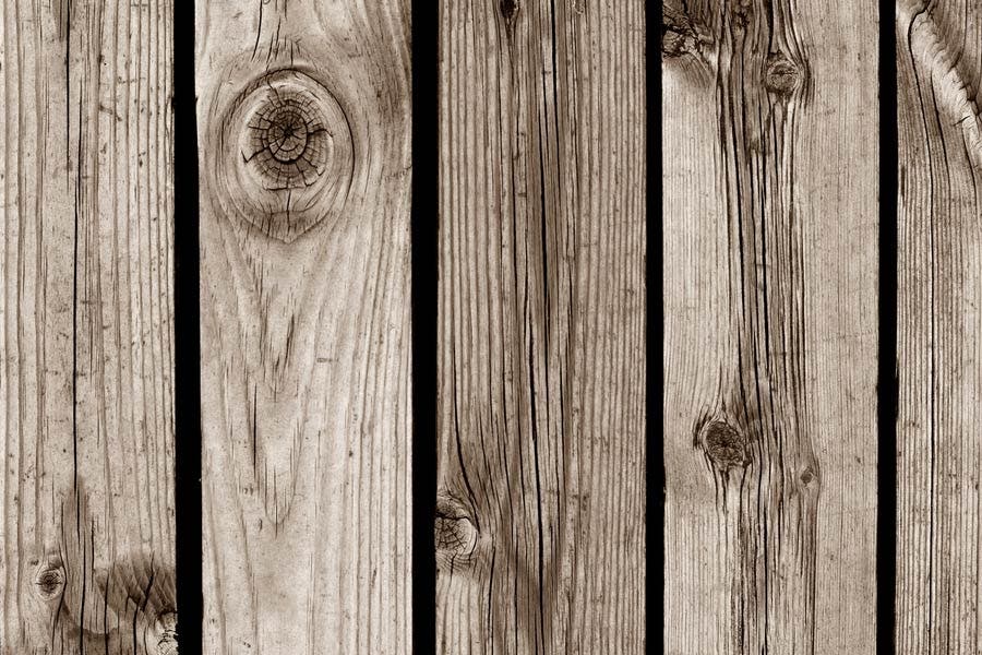Sepia photo of textured wooden gate