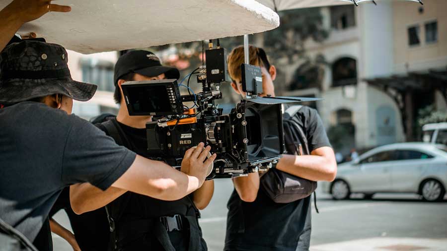 a man holding a professional 4K video camera