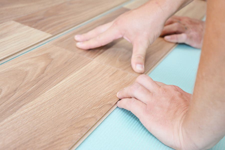 Installing wooden laminate flooring with insulation and soundproofing sheets