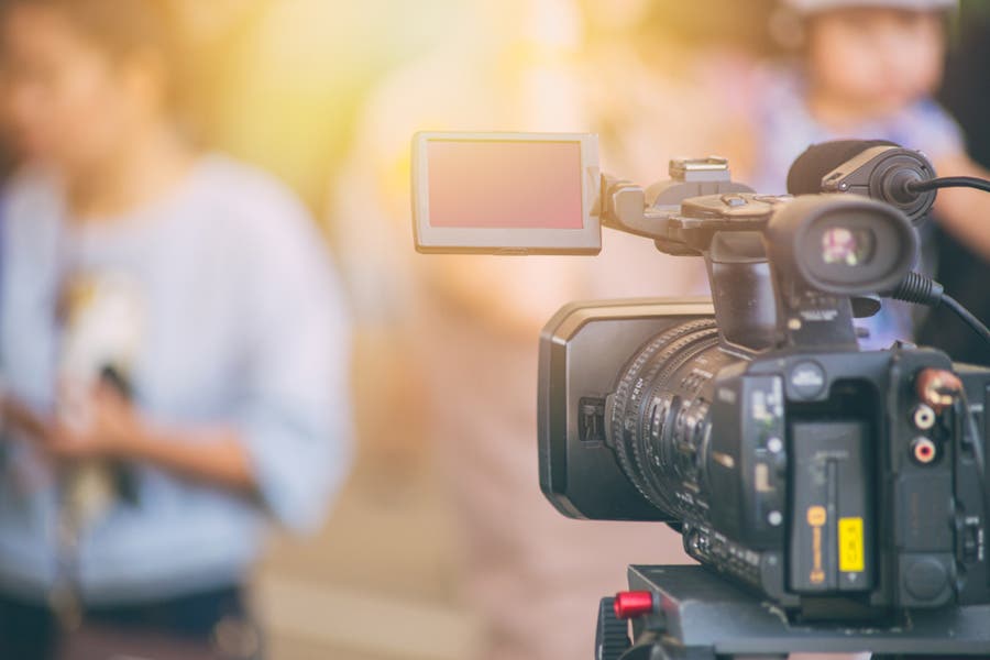 behind the scene photo of video camera in focus while shooting a documentary