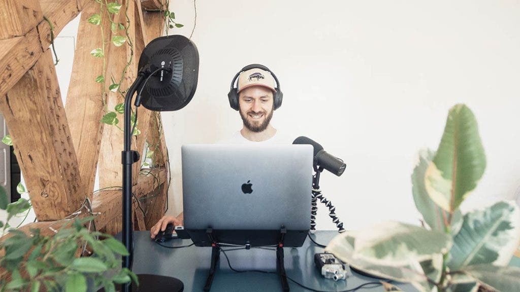 man with podcast microphone computer and light