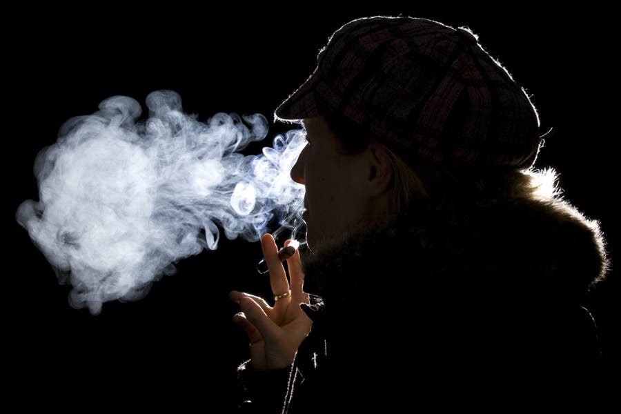 Using rim light for side portrait of woman smoking