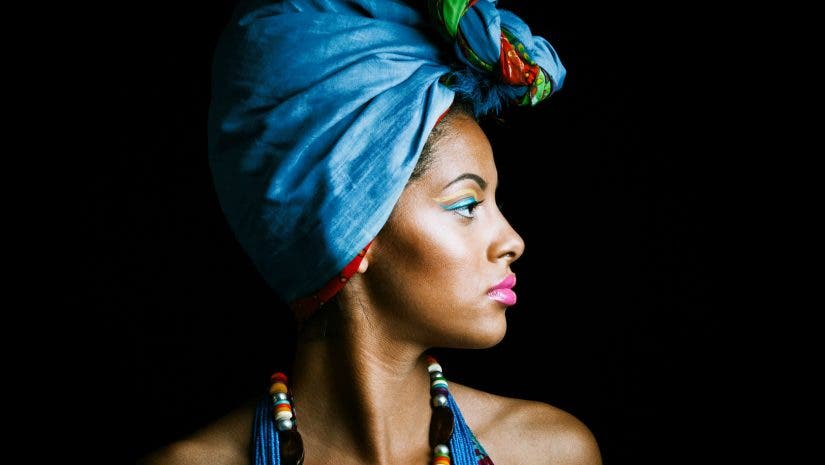 Studio side portrait of african woman in a colorful ensemble