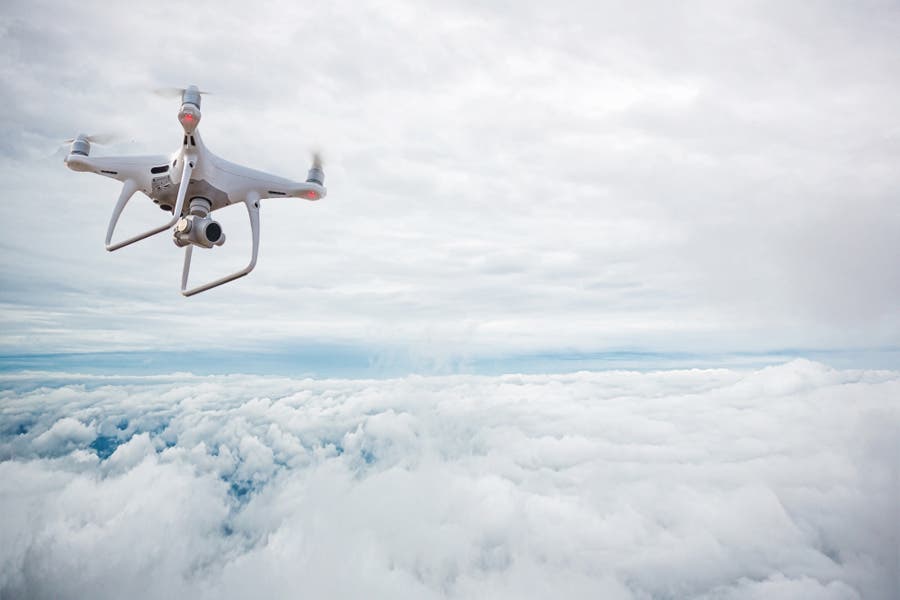 DJI 4k drone flying over clouds