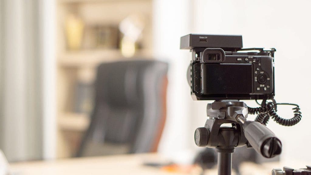 camera on tripod doing video recording