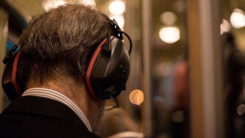 Man with noise-canceling headphones on train