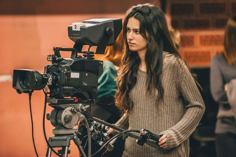female videographer behind camera