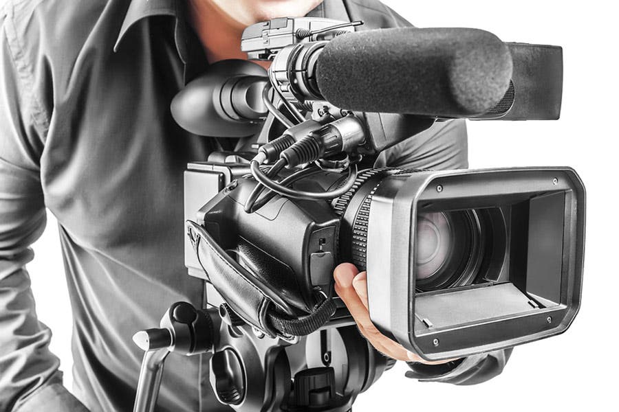 videographer and camera on clean white background