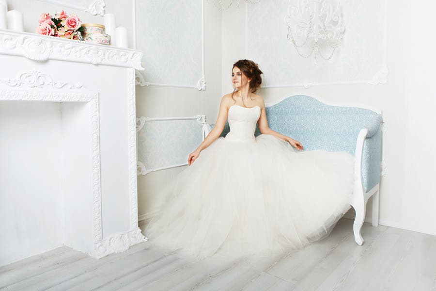 fashion wedding photo showing bride in clean white living room