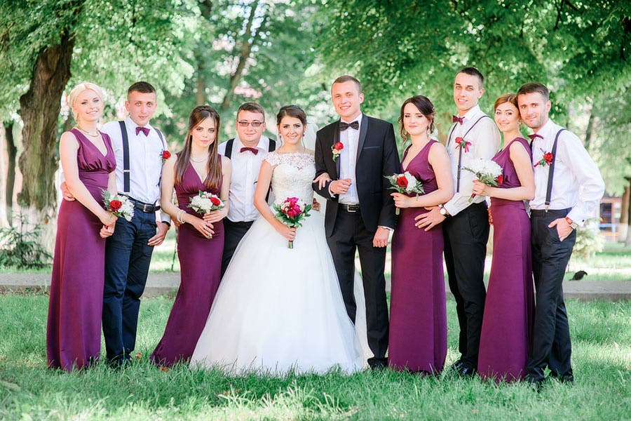 traditional wedding photo of couple and entourage