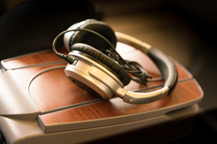 Noise-canceling headphones on an airplane desk