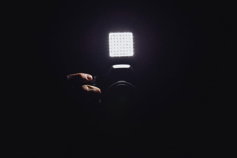 camera equipped with an LED light in a darkened room