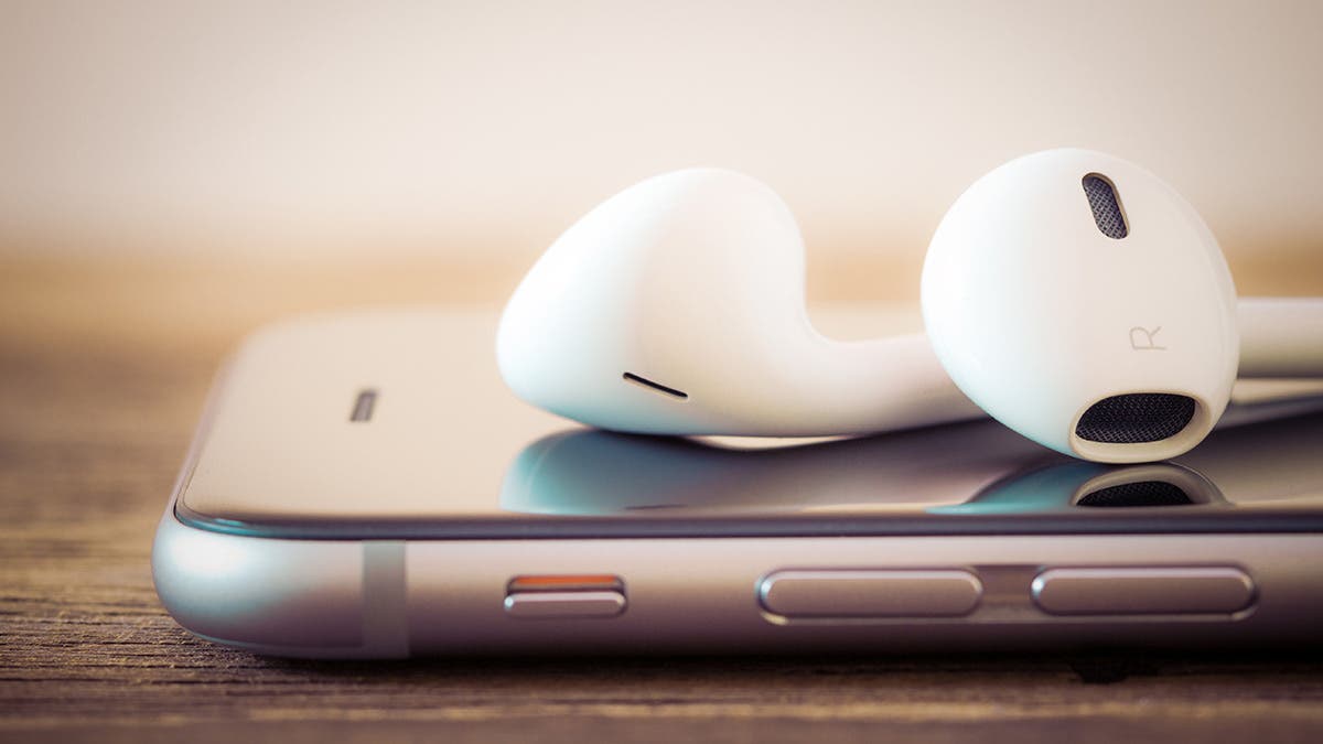 apple podcasts with headphones and iphone