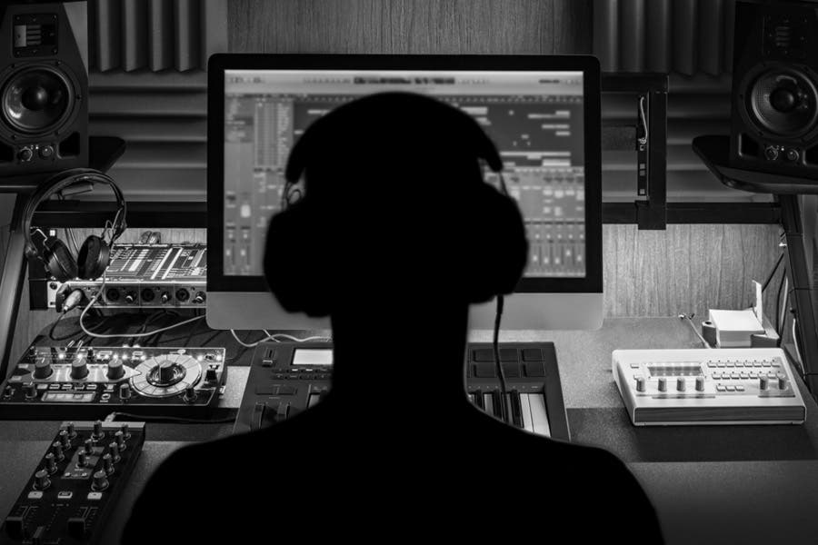 black and white photo of music producer in work desk