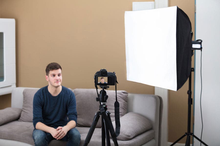 vlogger filming in front of a camera and softbox
