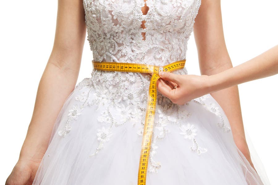measuring the waist of a fashion model