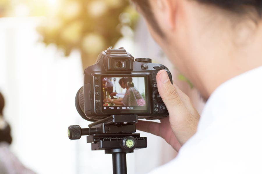 videographer monitoring scene on LCD viewfinder