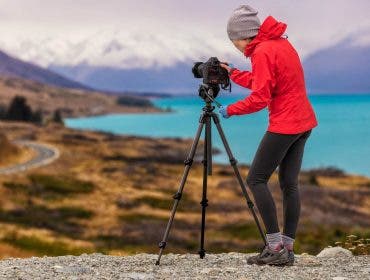photographer setting up camera on tripod for overlooking shot