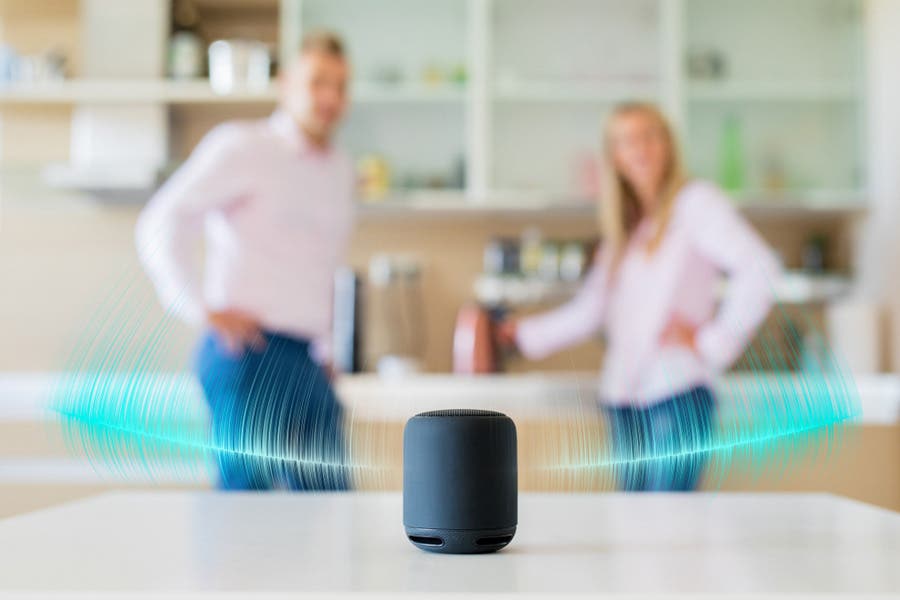 couple listening to multi-room speaker in the kitchen
