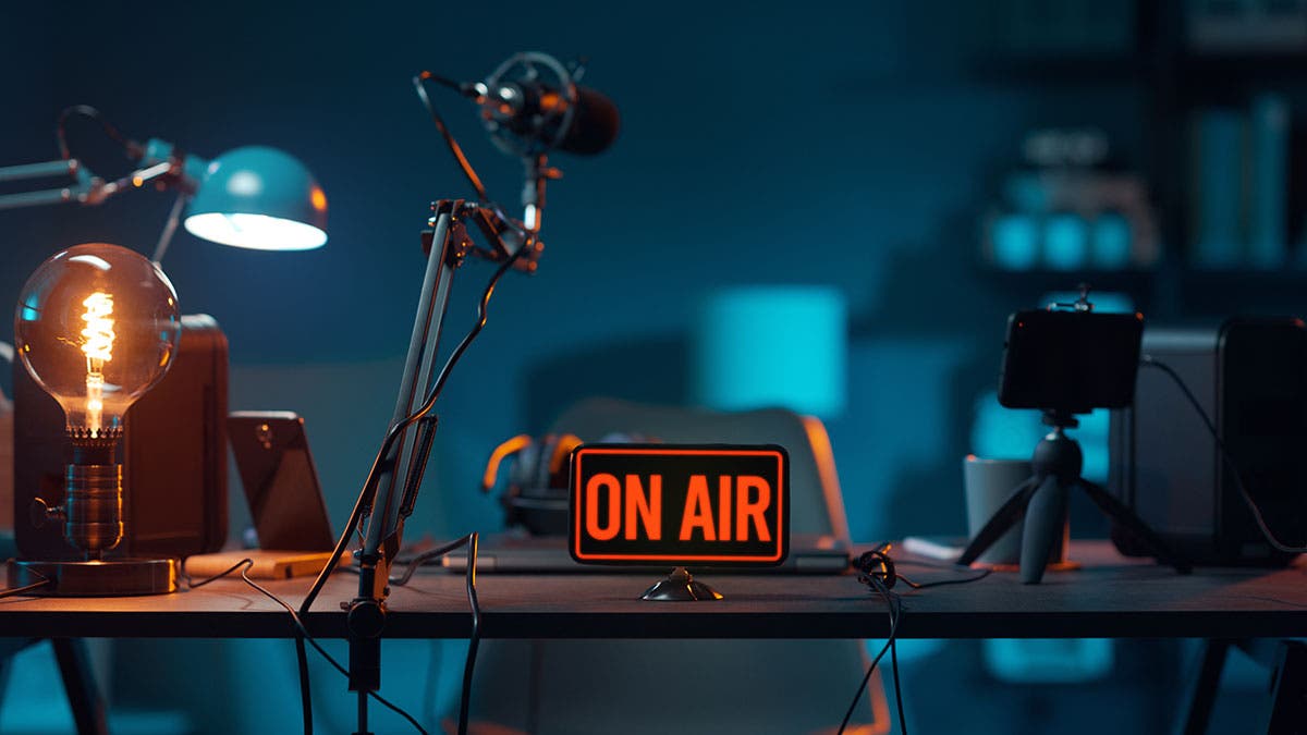 video podcast equipment on table on air sign