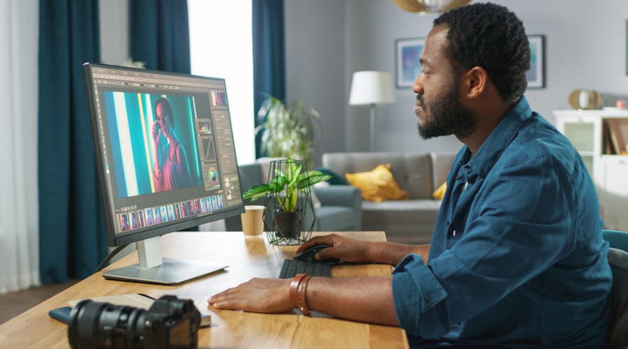 photographer editing image on desktop computer
