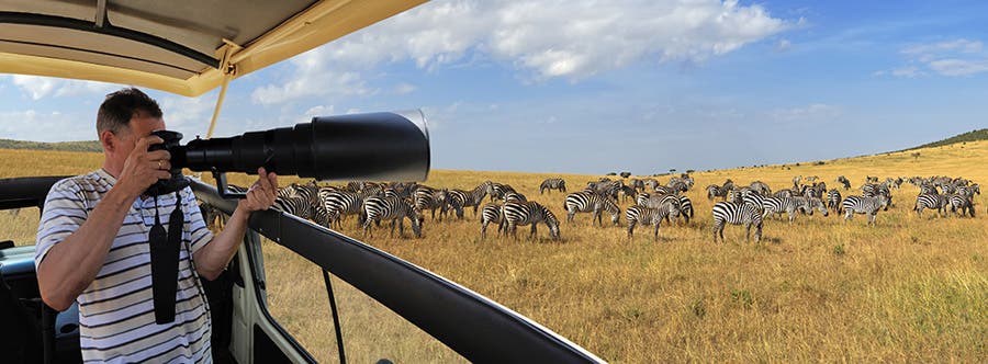 wildlife photographer with a very long telephoto lens