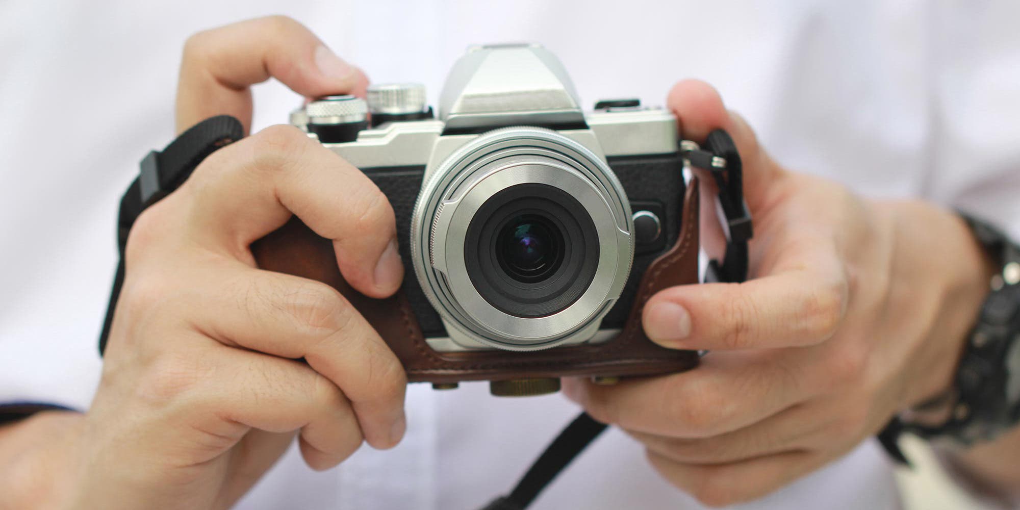 Man holding a mirrorless camera