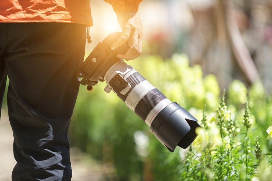 photo of a photographer using a lens hood