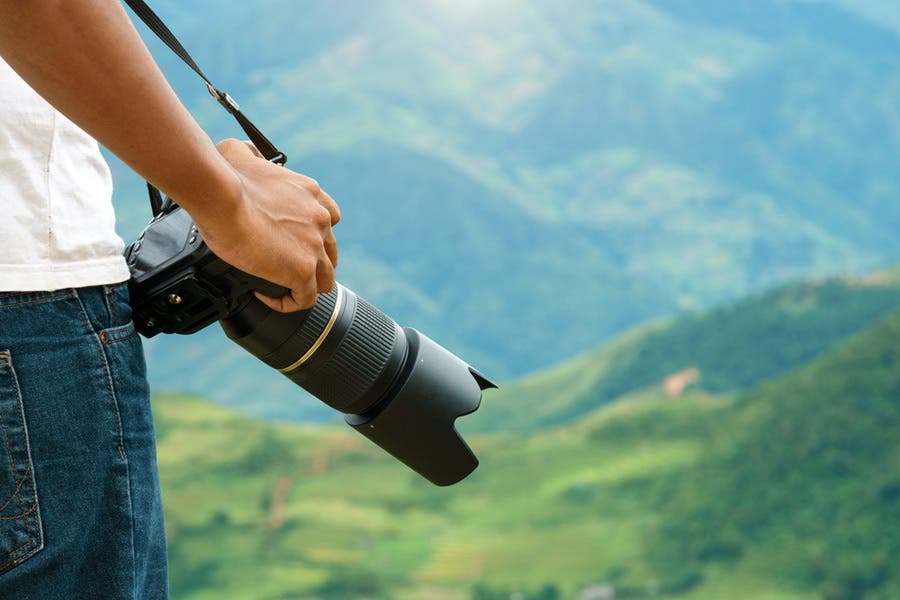 outdoor photographer using a lens hood