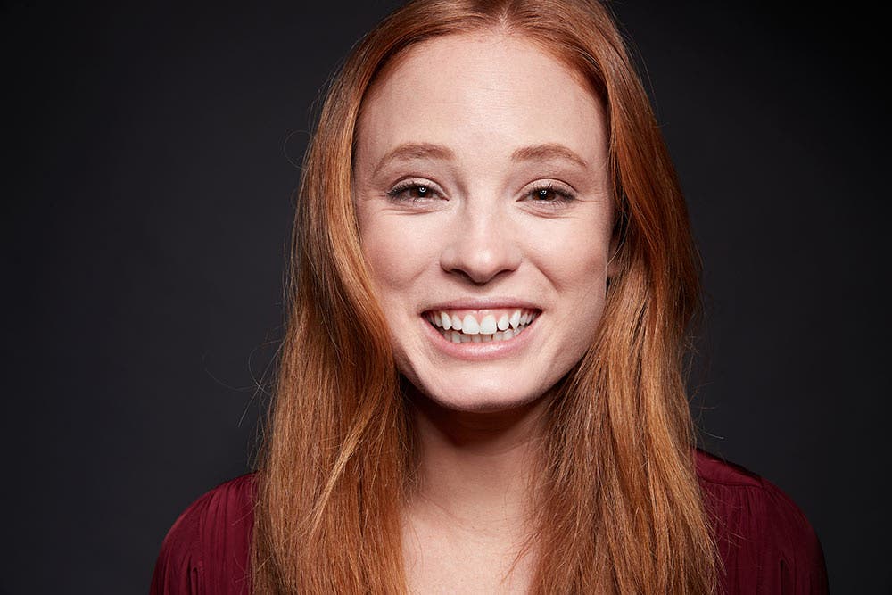 Daniel Norton smiling woman against backdrop