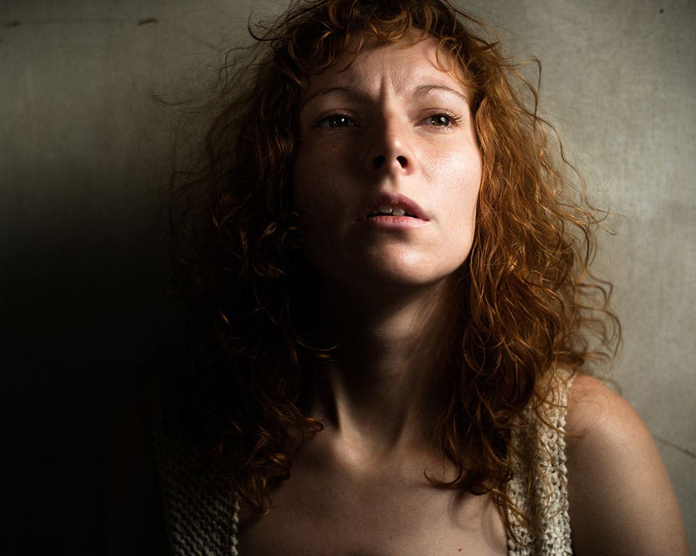 portrait photo of a woman against wall