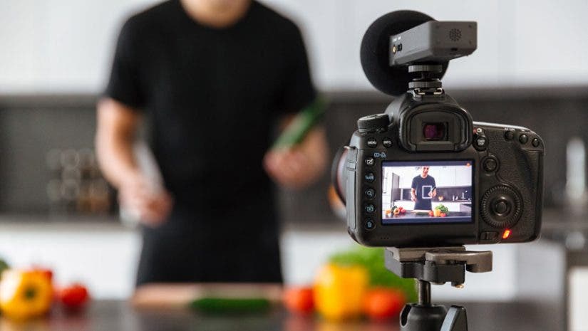 video camera filming a food blogger in a kitchen