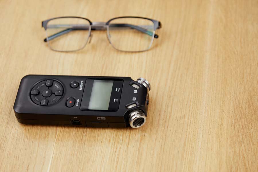 a digital audio recorder on a wooden table