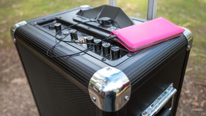 a portable PA system with a smartphone on top