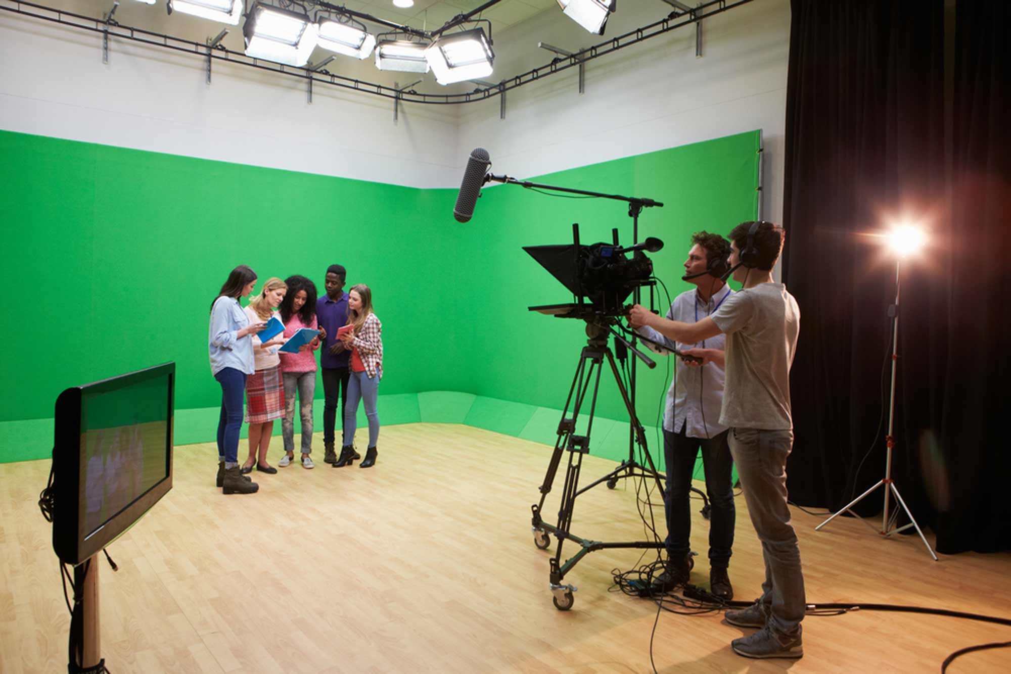 actors being filmed against a green screen in a studio