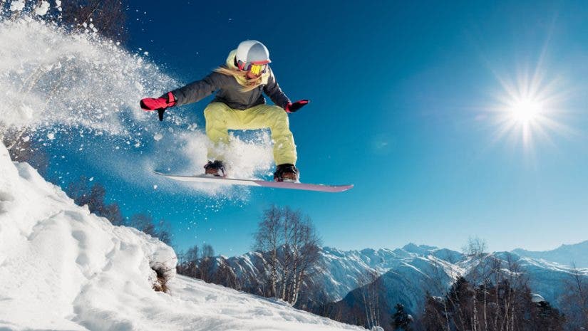 snowboarder jumping on mountain action photography