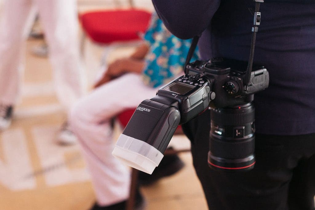 detachable camera flash on photographer's camera