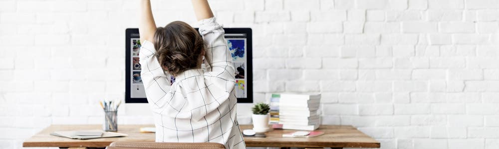 woman stretching at desk work from home