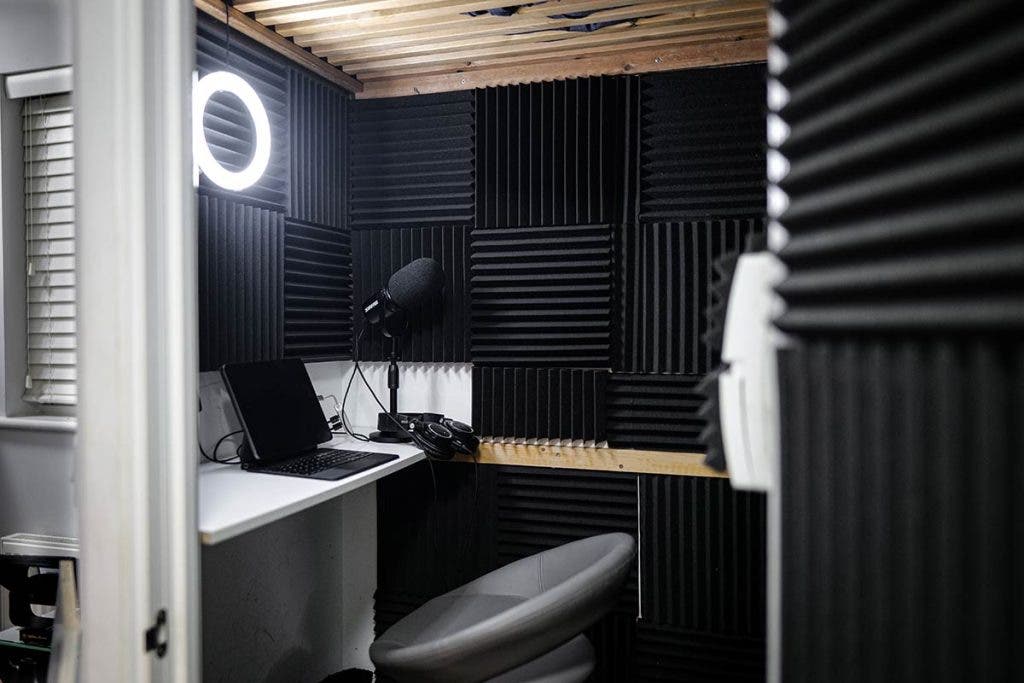 recording studio with soundproofing, microphone, and ring light