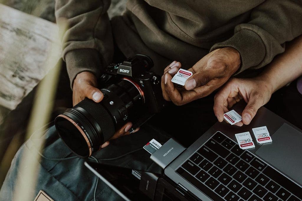 professional photographer with a camera and memory card