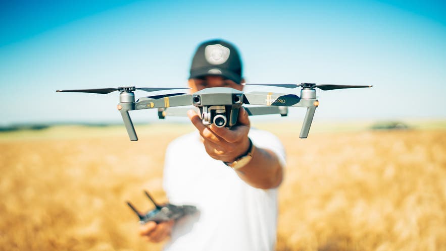 drone etiquette tips drone pilot with drone outdoors landscape